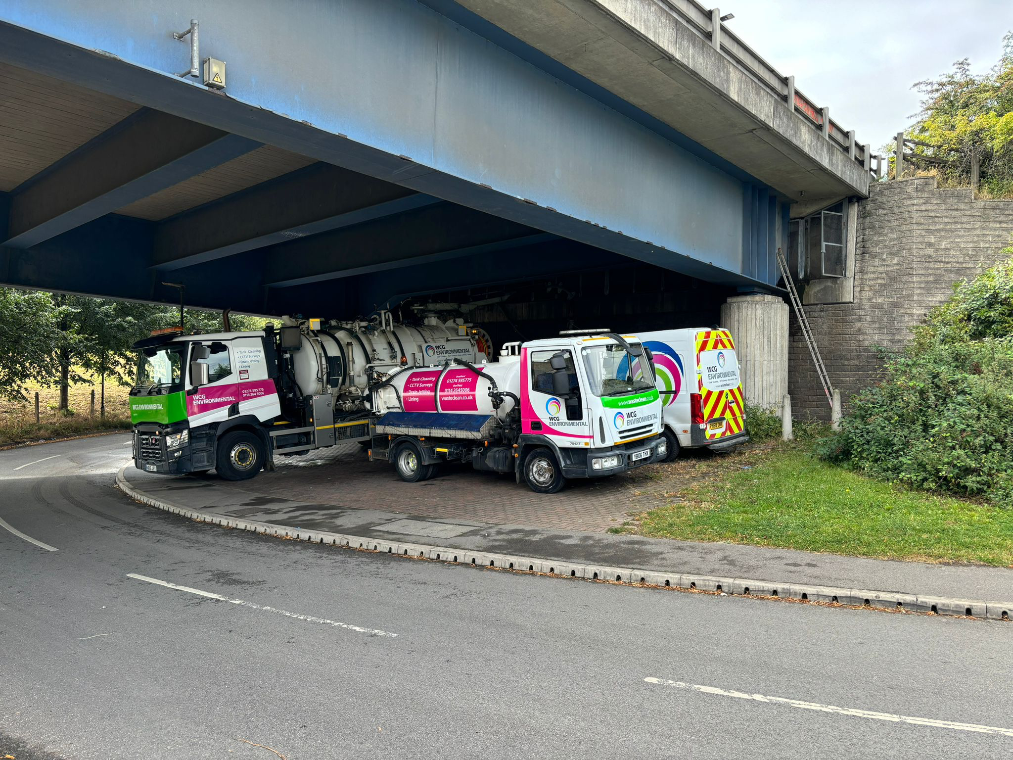 WasteClean fleet working beneath a bridge